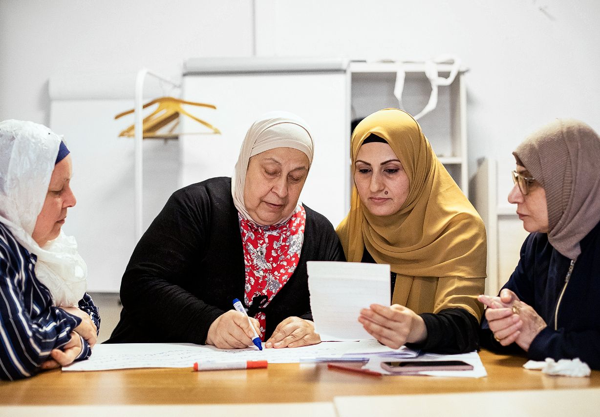 Foto: Vier Frauen mit Kopftüchern sitzen an einem Tisch und lernen gemeinsam. &copy; GIZ / 2022 Ali Saltan